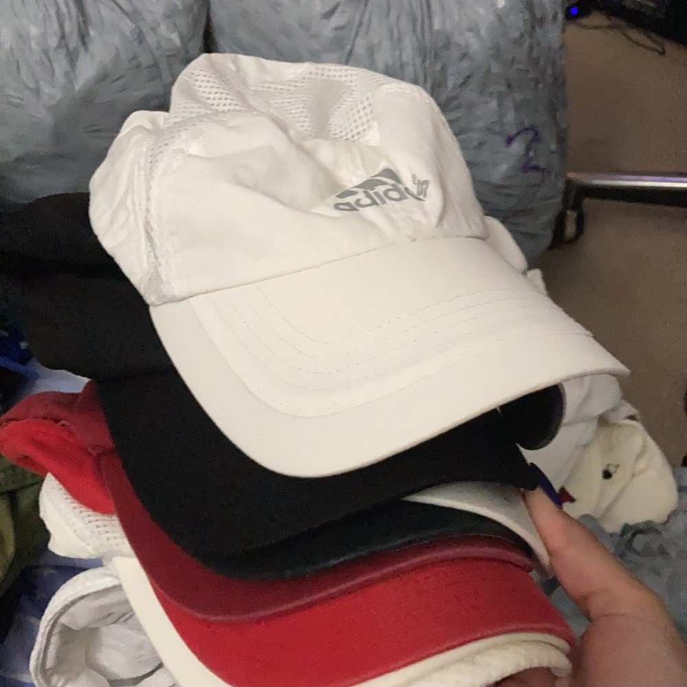 Stack of Adidas hats